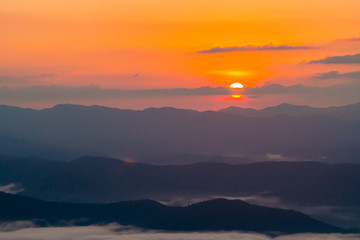  sunset overlooking mountains with Mist