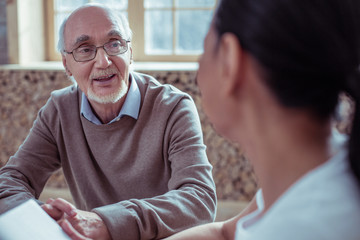 Handsome mature male person looking at his interlocutor
