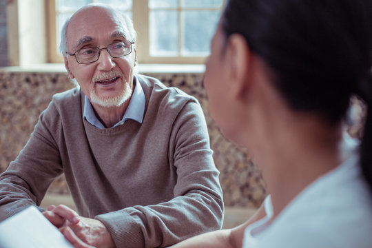Handsome mature male person looking at his interlocutor