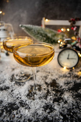 Picture of two wine glasses on blurred background with Christmas tree, lantern, clock