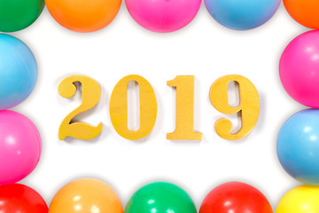 New year Concept.Word 2019 put on white background and the colored balls laying around.