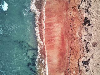 Fototapeta premium Nature Pattern. Pink Sand With Water Waves On Sea Coast