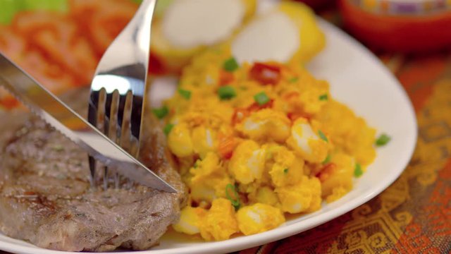 Meat Steak with corn tomatoes, lettuce and potatoes