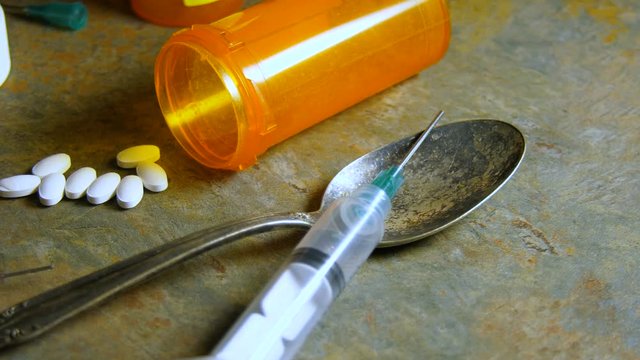 Needles, syringe, prescription pills, spoon and other drug paraphernalia