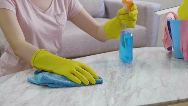 yellow gloves female doing housework