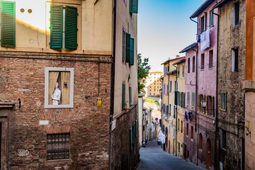 narrow cobblestone street in Siena