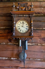 Old wooden pendulum hanging on a wall