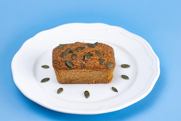 Gluten-Free pumpkin bread with pumpkin seed in white plate.