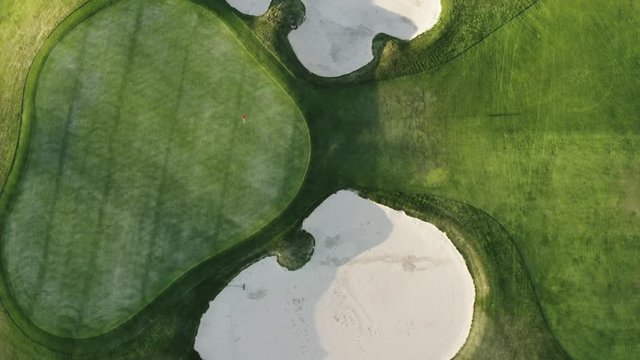 4K aerial drone footage' overhead birds eye view spinning shot of a hole on a golf course with sand traps at a country club in Colorado.