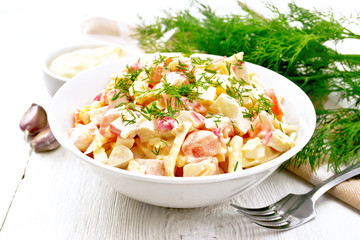 Salad of surimi and eggs with mayonnaise on wooden board © kostrez