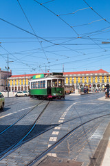 Fototapeta na wymiar Commerce Square with a beautiful green tram, Lisbon, Portugal