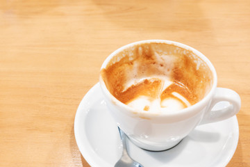 Hot coffee latte on a wooden table.