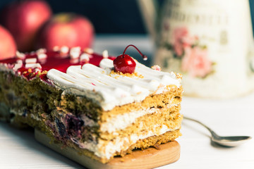 delicious cherry sponge cake with white cream and red jelly
