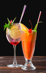 Alcoholic and non alcoholic cocktails on wooden table. Summer cold drinks