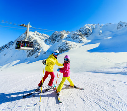 Happy family enjoying winter vacations in mountains . Ski, Sun, Snow and fun.