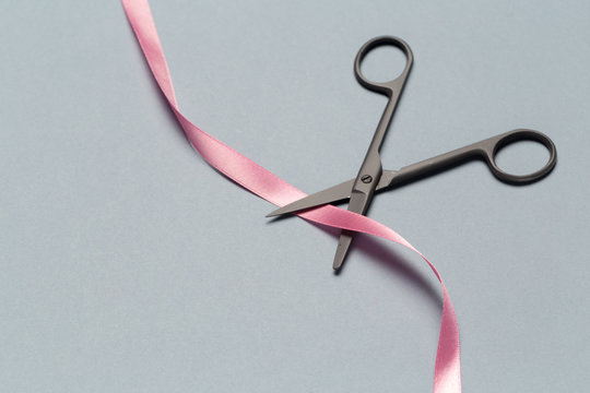 Grand Opening illustrated with  scissors and a pink ribbon on a gray background - Powered by Adobe