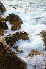 Crimea. Waves break against stones. Splashes fly. Sea, rocks.