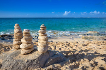 Fototapeta na wymiar Stacks of stones in balance at a beach