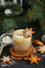 Gingerbread snowflake cookie, a cup of cappuccino for christmas.