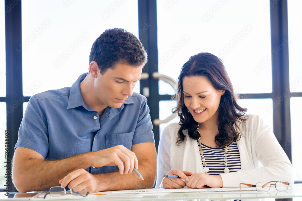 Wall mural image of two young business people in office