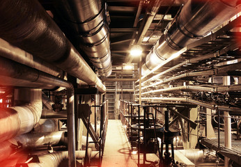 Equipment, cables and piping as found inside of a modern industrial power plant