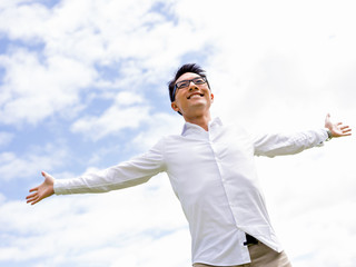 Young happy and successful businessman during his break in park