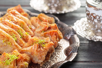 Turkish arabic dessert baklava with honey and nuts on a silver plate