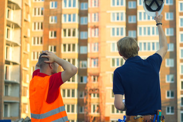 Fototapeta premium customer in stress and constructor foreman worker with helmet and vest
