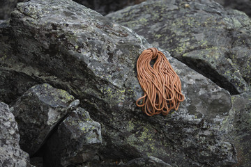 Bights of dynamic rope for sport climbing lying on a large stone.