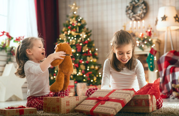 Fototapeta na wymiar girls opening Christmas gifts
