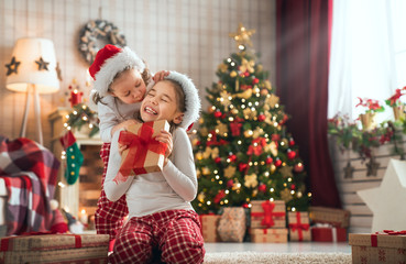 girls opening Christmas gifts