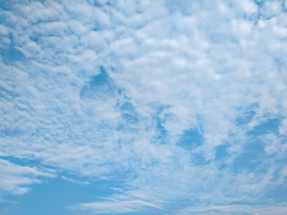 cloudscape with white altocumulus clouds at evening
