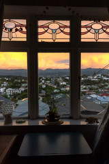 View thru the window of a sunset over Wellington city, New Zealand