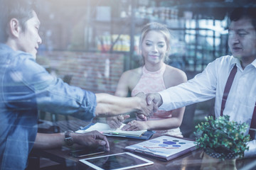 businessman signing contract and handshake after business negotiations to finally success