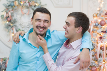 Two men in a New Year's studio. Two brothers are joking