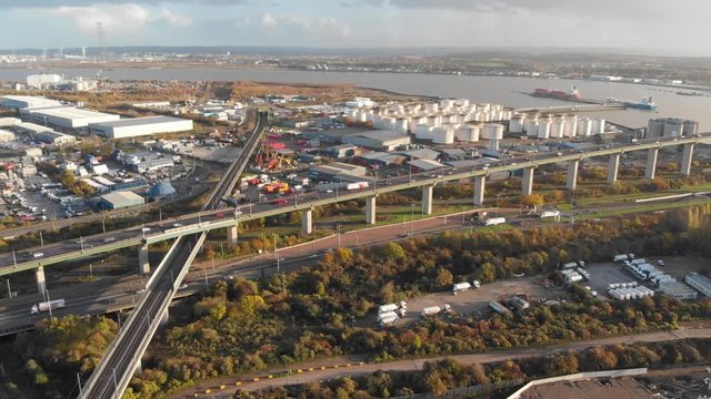 A static aerial view of the traffic going in and out the Dartford Crossing and oil storage depot in the distance
