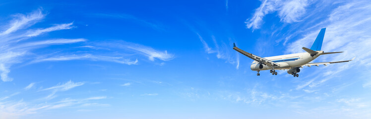 Airplane flying in the blue sky,panoramic view