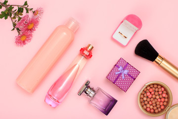 Obraz premium Gift boxes and cosmetics on a pink background.