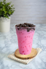 Strawberry milk tea with iced topping bubble in glass plastic