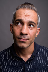 Obraz premium Face of handsome Persian man thinking and looking up