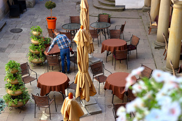 View on chairs and tables in cafe of Italian courtyard loggia arcade of the Korniakt palace (kamienica Królewska) on old town in the center of Lvov © watcherfox