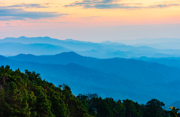 Beautiful scenery landscape of rainforest on mountain ridge with mist  at sunset in the evening.