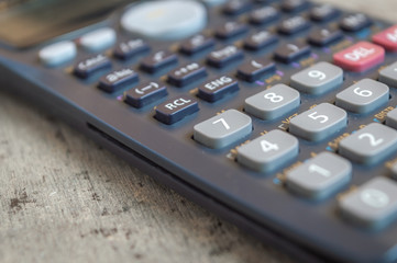 Close up of a black scientific calculator with a shallow depth of field