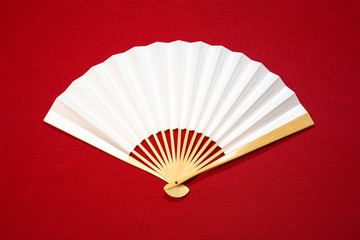Japanese Traditional White Fan on red background