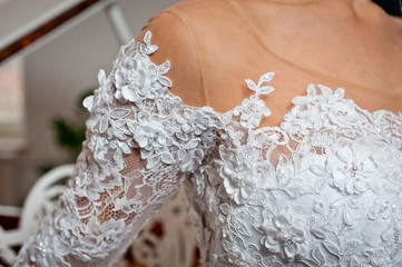 Beautiful white wedding dress with embroidery close-up shot