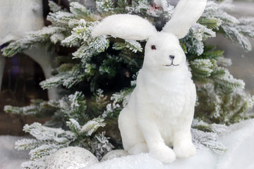 Ornaments christmas tree. gifts under the tree. White rabbit figure