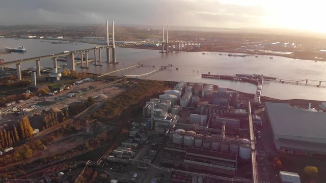 An aerial view showing heavy traffic on Dartford Crossing tunnel and Queen Elisabeth II bridge at sunset