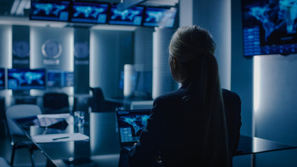 Female Special Agent Works on a Laptop in the Background Special Agent in Charge Talks To Military...