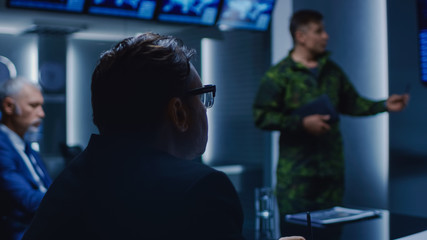High-Ranking Military Man holds a Briefing to a Team of Government Agents and Politicians, Shows Satellite Surveillance Footage. 