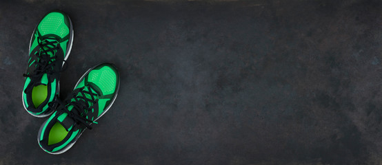 New green sneakers isolated on black background with copy space